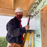 Photo of Lyle Hanna volunteering at a Habitat for Humanity home building project